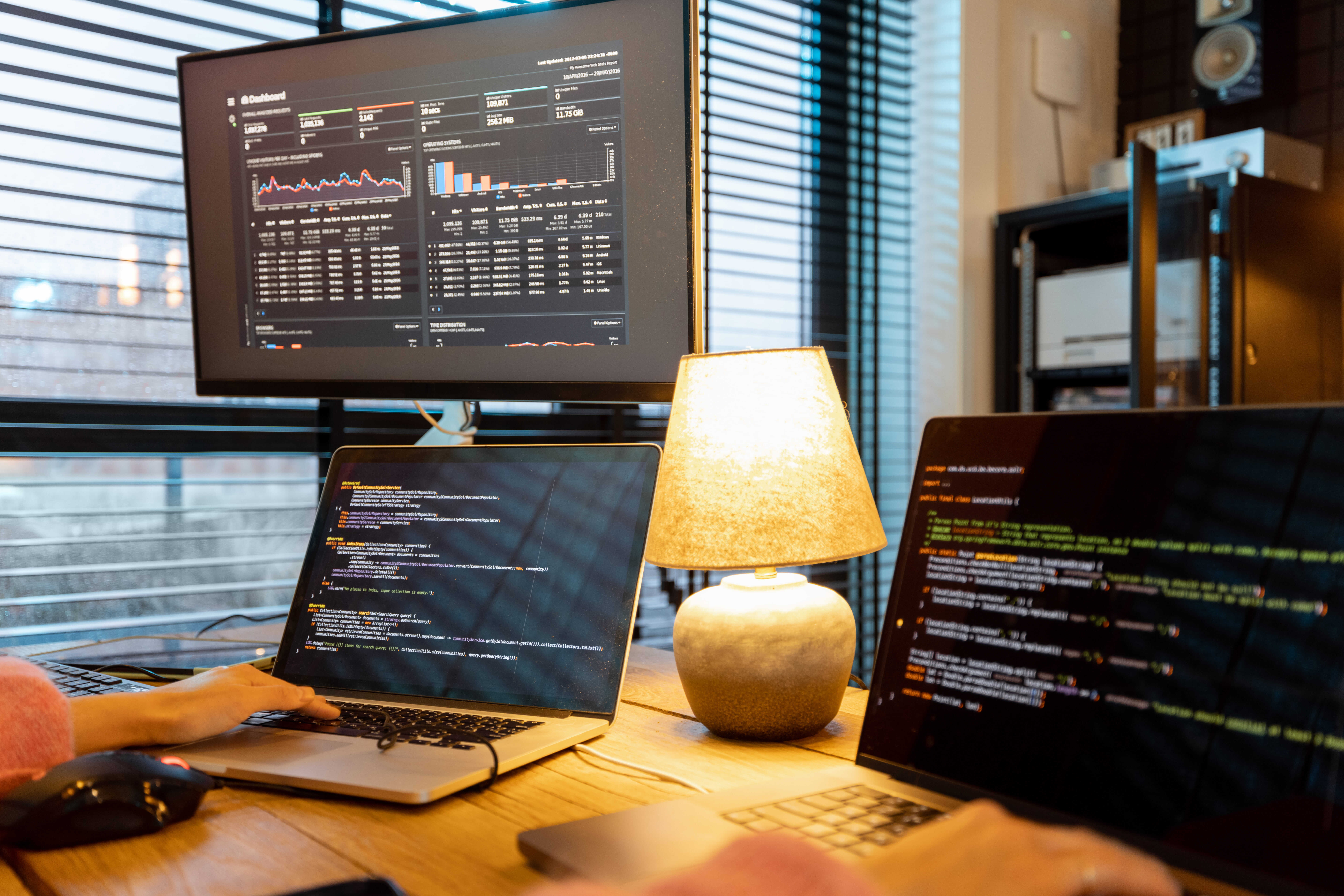 Website development workspace with code on screens